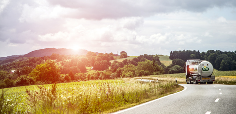 Arla truck in sunny landscape