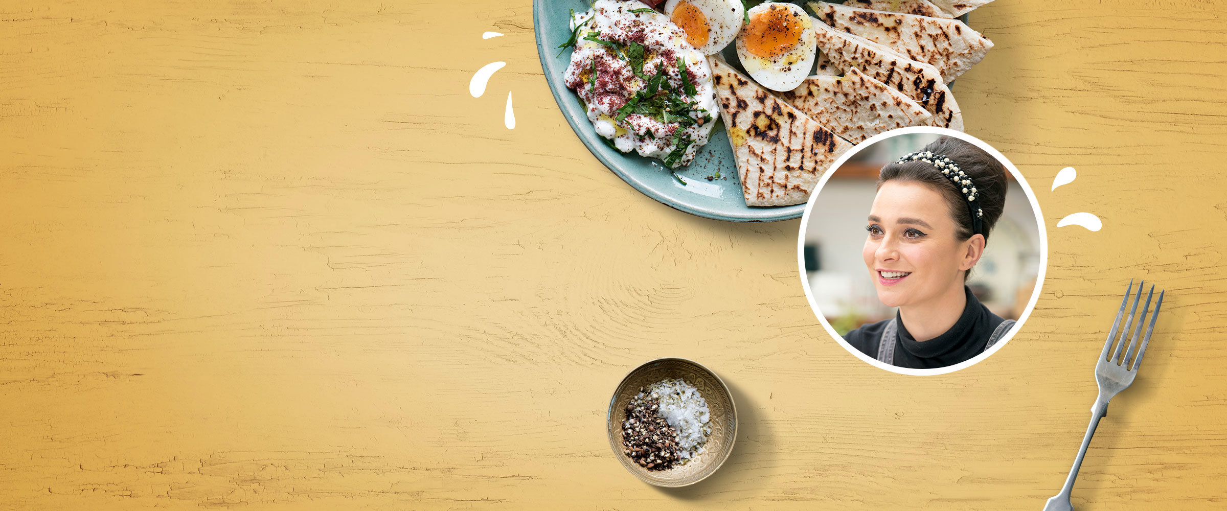 Turkish breakfast on a yellow coloured wooden backdrop with an inset portrait of Gizzi Erskine