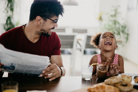 Dad and daughter having breakfast 